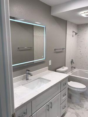 Quartz - countertop and tub surround.