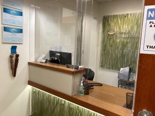 Plexiglass window at receptionist desk