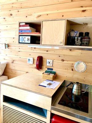 Inside the trailer comes with a mini fridge, stove, and yea kettle with mugs