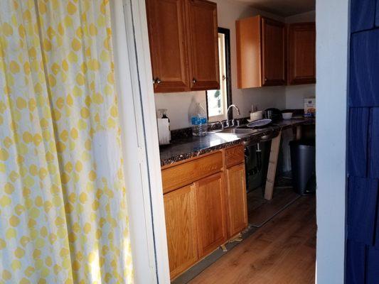 Kitchen base cabinets after flood with staining to match existing uppers