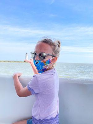 Lori took this picture of my daughter "holding" the lighthouse.