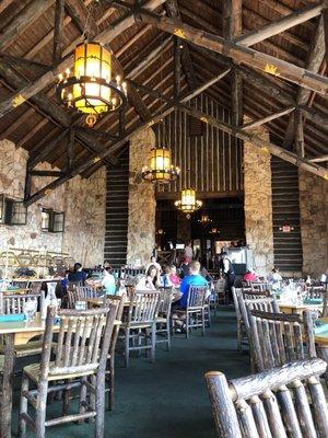 What a magnificent room: stone walls, timber ceiling, beautiful chandeliers, and.... picture windows...