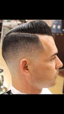 This is a mid razor fade gentleman cut papador style haircut complemented by light edge up with hair style with palm aid.