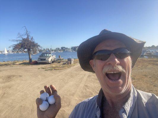 Golf balls I found in the water and MICHAEL and his dog living in their minivan with a shoreline view