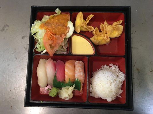 Lunch sushi bento box: crab rangoons, 5 piece nigiri, steamed rice and salad with ginger dressing