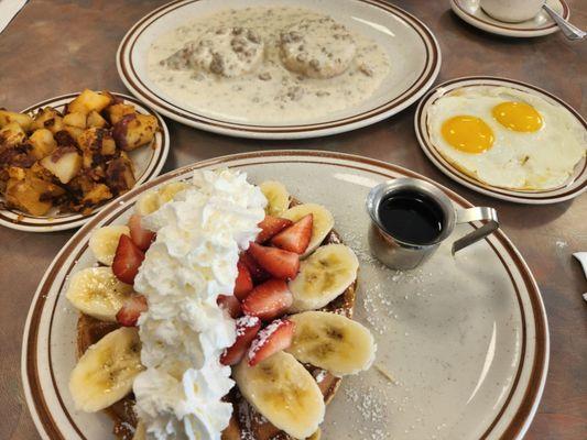 Red, white and blue pancakes sausage and ravy biscuit hash brown and delicious eggs.