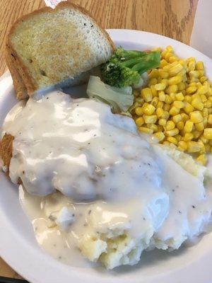 Monday's Special Chicken Fried Steak w/ country gravy, mashed taters, corn + a piece of broccoli & cauliflower and Texas toast.