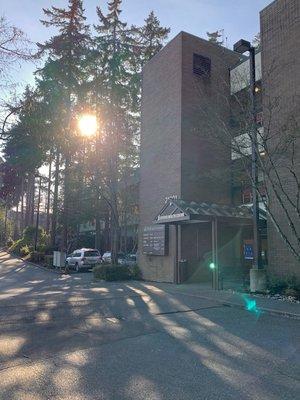 A sunny welcome at the building's front entrance.