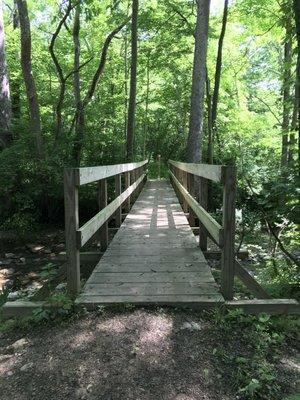 Bridge at the connection from the river loop to others near the meadow and hills