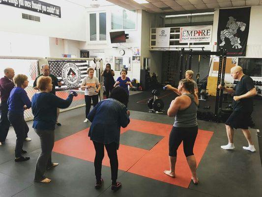 Coach Kathy working with the fighters shadow boxing with weights!