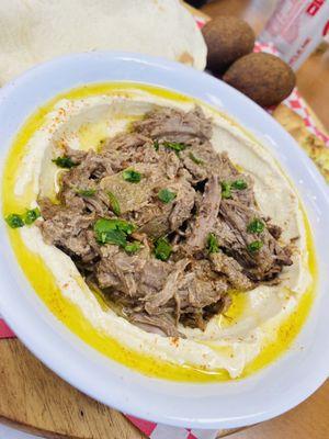 Hummus topped with meat!