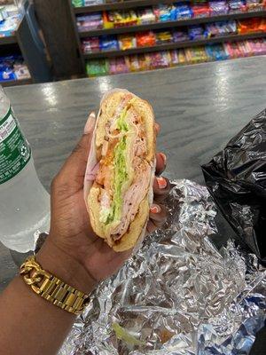 Hot Smoked Turkey Sandwich on a bagel with mayo, swiss, provolone, lettuce, tomatoes Red Onion, salt and pepper