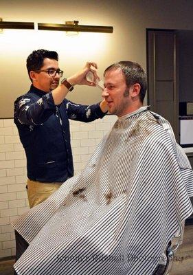 Master Barber Hugo performing a Haircut.