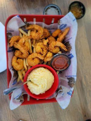 Fried shrimp basket with fries, cheese grits and  a corn fritter