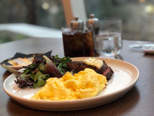 Petite tenderloin and eggs with mixed green salad for breakfast