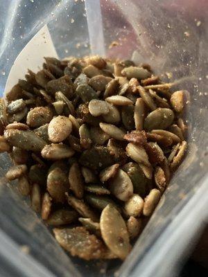 Close up view of opened 8oz package of Sweet & Spicy Pumpkin seeds