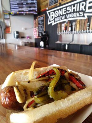 Housemade sausage with flame grilled peppers and onions.