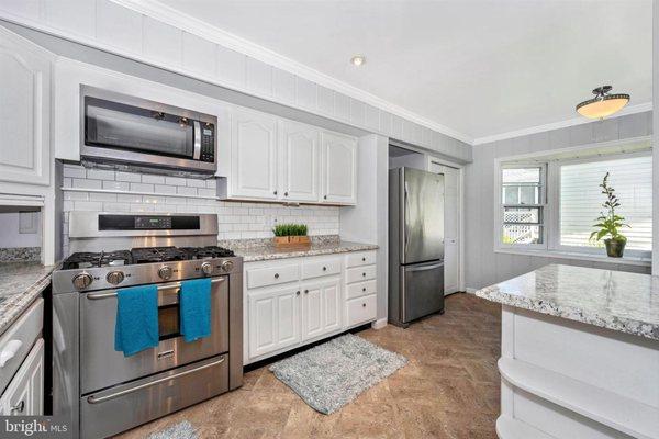 KITCHEN AFTER RENOVATION.  NOTE THE STOVE HOOD WAS REPLACED WITH A MICROWAVE.