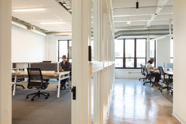 the dividing line between open and assigned desks.