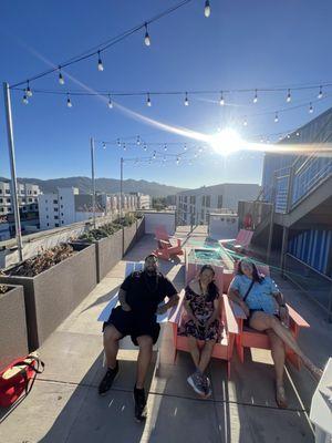 Lots of seating and fire pit on the rooftop of the building