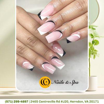 Chic contrast: soft pink nails adorned with black and white strokes merge elegance with edge, creating a captivating harmony of colors.