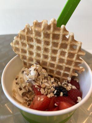 Yellow cake batter and Vanilla frozen yogurt.  Toppings include, Strawberries, raspberries, boysenberries, almonds and waffle cookie.