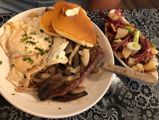 Steak and eggs (over easy) with a side of corned beef and potatoes