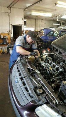 Just another day of working on cars. Here is Dave wrenching away!