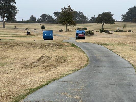 Large equipment roaming the course during play.