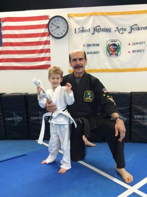 Receiving his white stripe belt