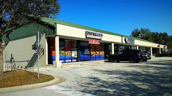 Look for the green roof buildings near the Nissan dealership