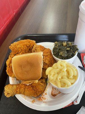 Spicy mixed plate with collard greens, mac&cheese, roll, and grape cool aid.