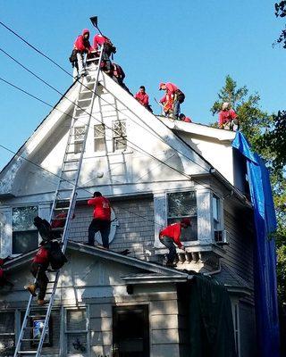 Teamwork on a shingle roof