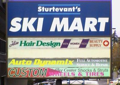 Turn in at Ski Mart & go to the very back & turn left & park.