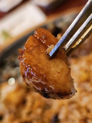 A fork holding a piece of Scallop.