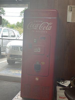 Antique cola dispenser.