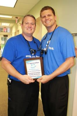 Drs. Miller and Wilharm holding the Dentistry From The Heart 2015 Host plaque. To see more pictures from DFTH, visit our Facebook page.