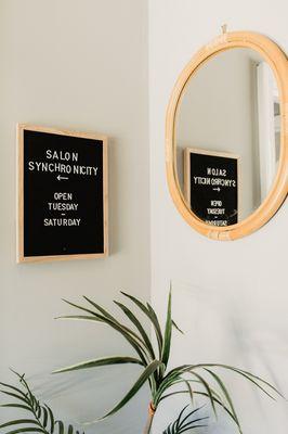 This is the entryway area of Salon Synchronicity. Our main door is located just to the left of the sign pictured here.