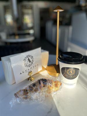 Sitting down for a moment, with coffee and wrapped house-made chocolate croissant