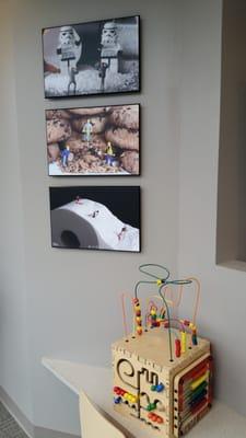 Complete children's play space in waiting g room.  Books, toys, small TV and Lego Star Wars art!