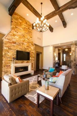 Beamed ceilings, rustic barnwood flooring and this grand tiled fireplace surround are complemented with a modern gas fireplac...