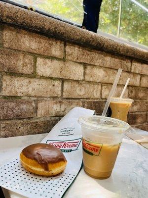 Chocolate glazed custard filled doughnut with Ice Coffee.