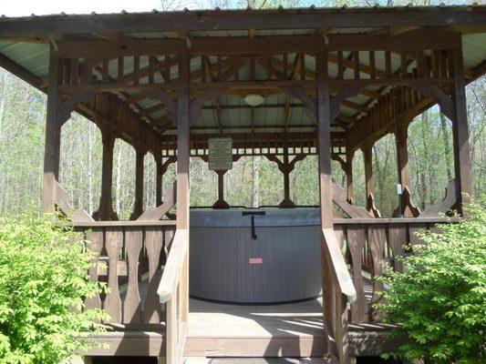 Common area hot tub shared among the 4 smaller cabins