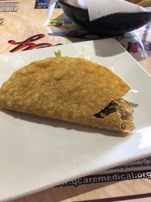 Taco served missing a small part of the shell. Beef was dry and flavorless.