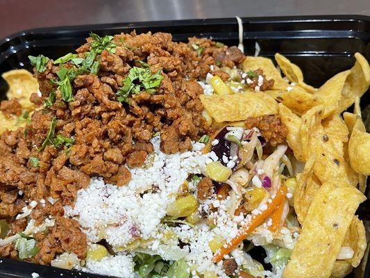 Comal Meatless Bowl with Rice, Black Beans, Roasted Corn, Slaw & Fritos.