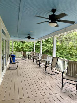 Lots of outdoor seating under a covered porch