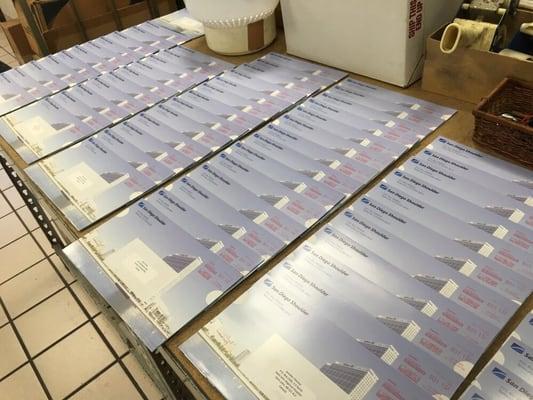 Large quantity of brochures being mailed for a local business.