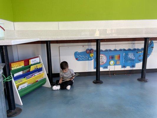 Children's area with books and activities at the front of the store.