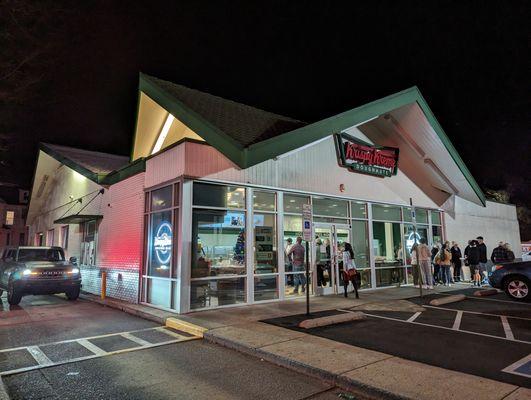 Outside at night. Storefront and drive-thru.