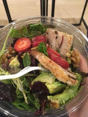 Mixed greens with turkey strawberries avocado and walnuts. Super fresh